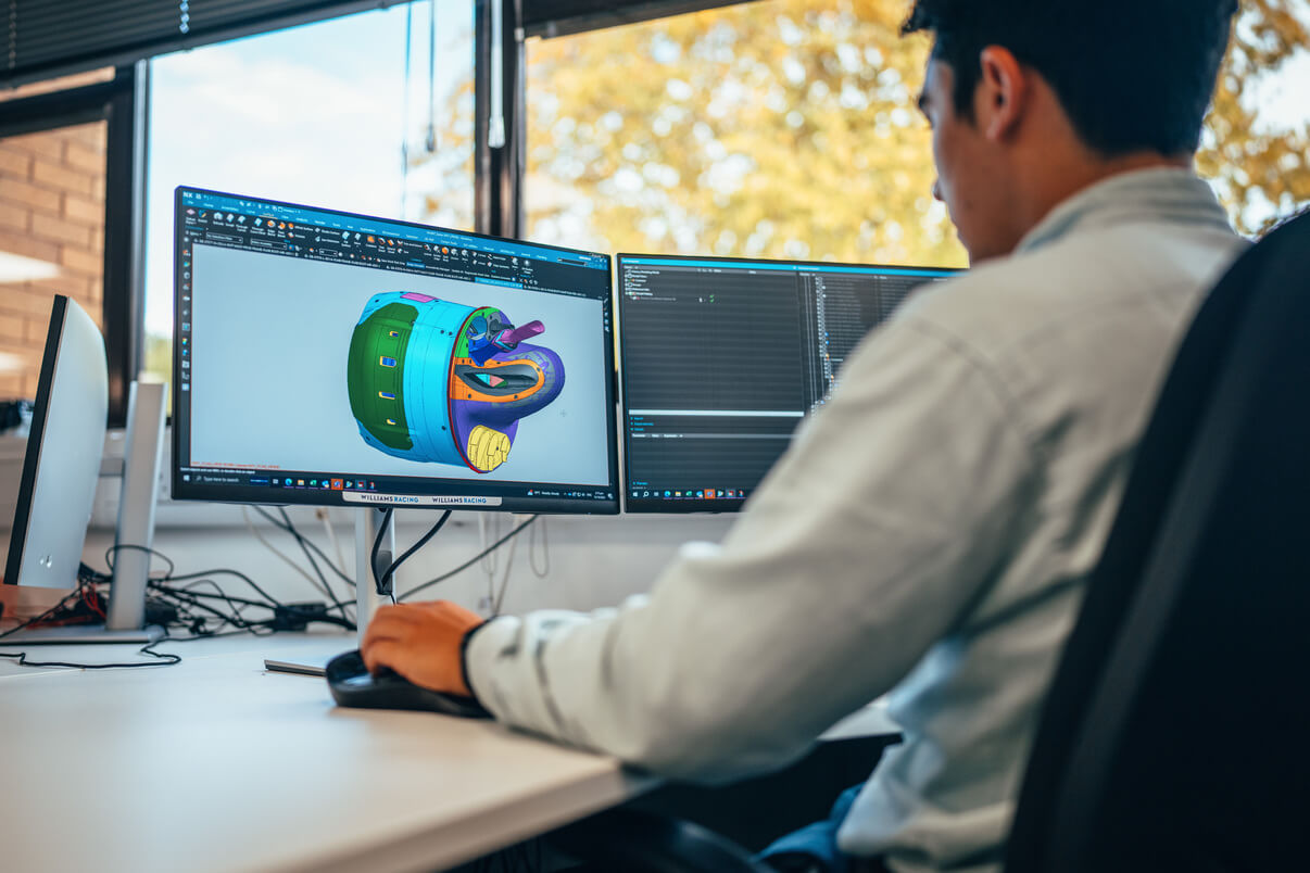 A design engineer at Atlassian Williams Racing sat at his desk working on a design