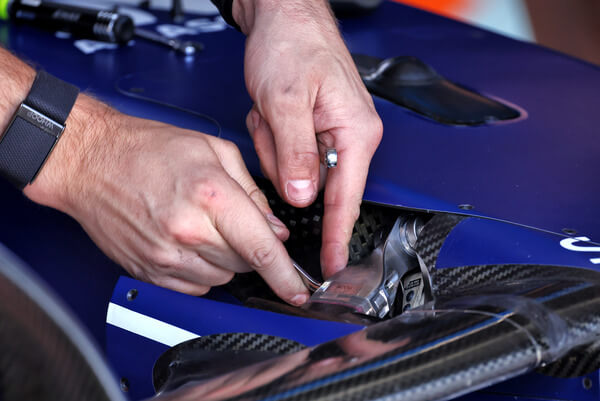 A mechanic working on an F1 car
